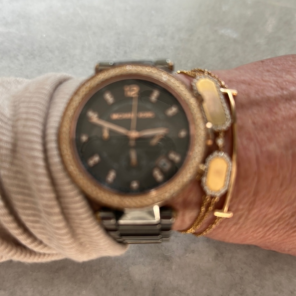 Michael Kors watch with white stones on gold tone bezel and steel bracelet